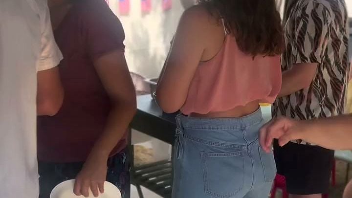 Des invités se servent au buffet sous la tonnelle, lors d’un événement en extérieur.